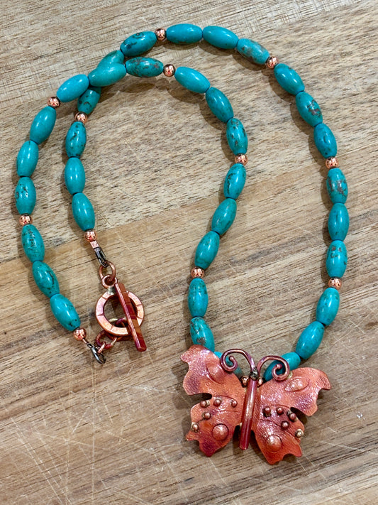 Artisan Crafted Copper and Brass Butterfly with Turquoise Tone Oval Barrel Beads